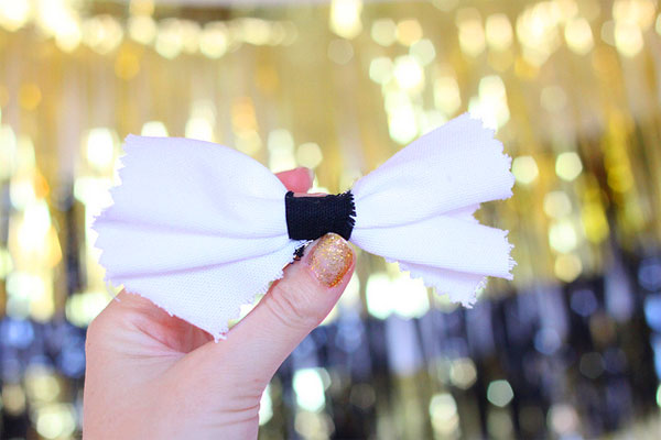 KellyGolightly.com shows how to diy cute bow tie pins that double as party favors and decor, as well as hair pins/brooches; diy how to make bowties; how to make bowtie pins; how to make bowtie hair pins; easy oscar party decor; easy oscar party ideas.