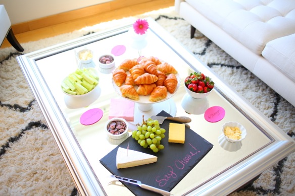  To add a glamourous touch, I moved a mirror from the bedroom into the living room and placed it on top of our coffee table to display food and drinks.