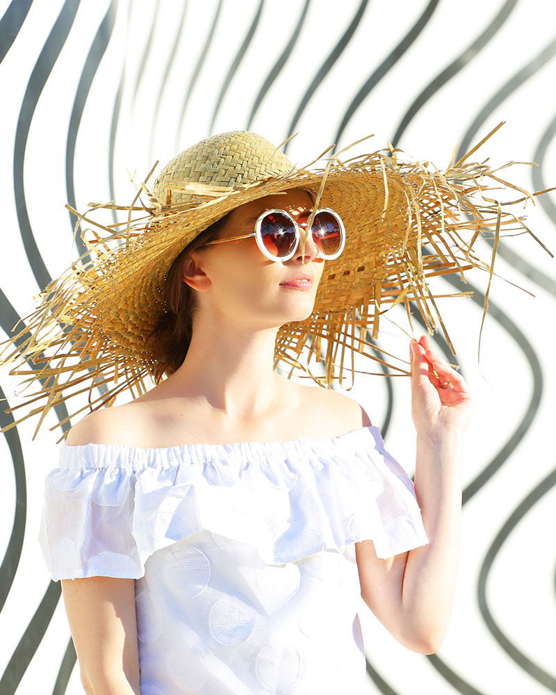 Desert X: Fashion blogger Kelly Golightly visits Phillip K Smith's Desert X installation in Palm Springs wearing a Sail to Sable LWD + Lack of Color straw hat. #kellygolightly #desertx #lwd #lackofcolor #murals