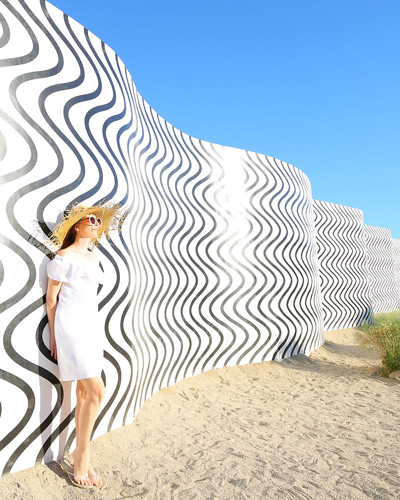 Desert X: Fashion blogger Kelly Golightly visits the Desert X installation in Palm Springs wearing a Sail to Sable LWD + Lack of Color straw hat. #kellygolightly #desertx #lwd #lackofcolor #murals #palmspringsmurals