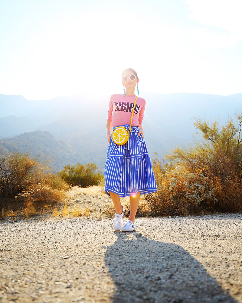 Colorful fashion blogger Kelly Golightly wearing cute Astrology Tshirts: Vision Aries paired with blue-and-white striped skirt + lemon bag. #kellygolightly #jcrew 