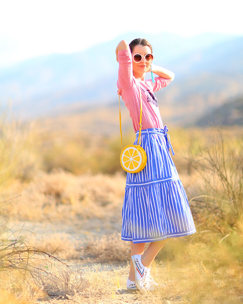 How To Style a Striped Skirt: Colorful fashion blogger Kelly Golightly wearing Feiyue sneakers + pink shirt paired with blue-and-white striped skirt + lemon bag. #kellygolightly #jcrew #feiyue #stripes
