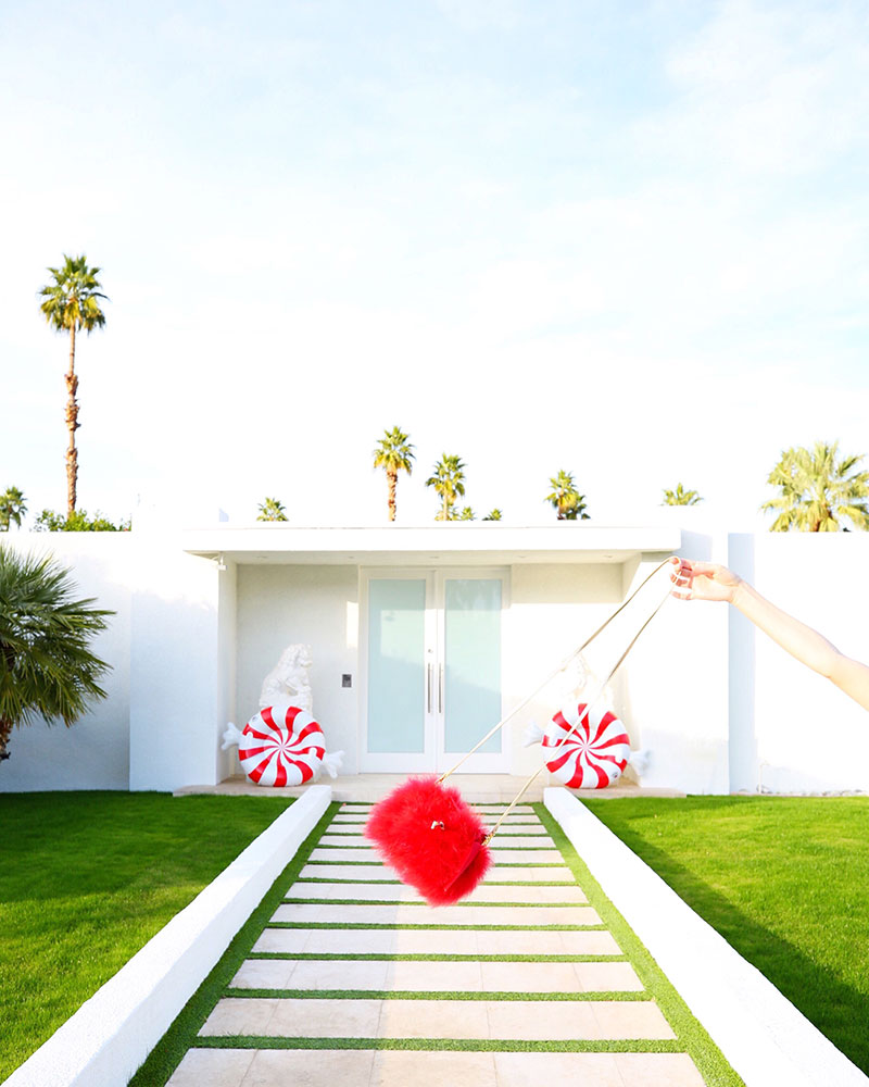 Frances Valentine Red Furry Bag in front of one of the most famous doors in Palm Springs. 