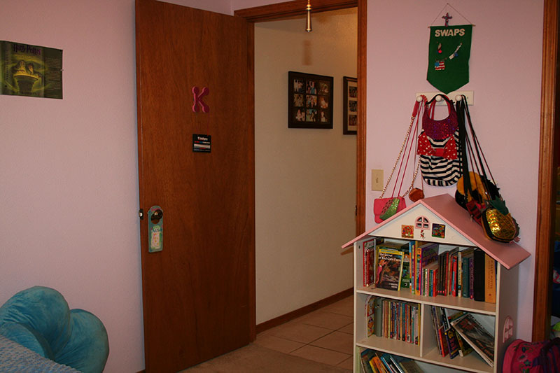 bed room door with letter k hanging, doll house with books, and bags for One Room Challenge Week 6