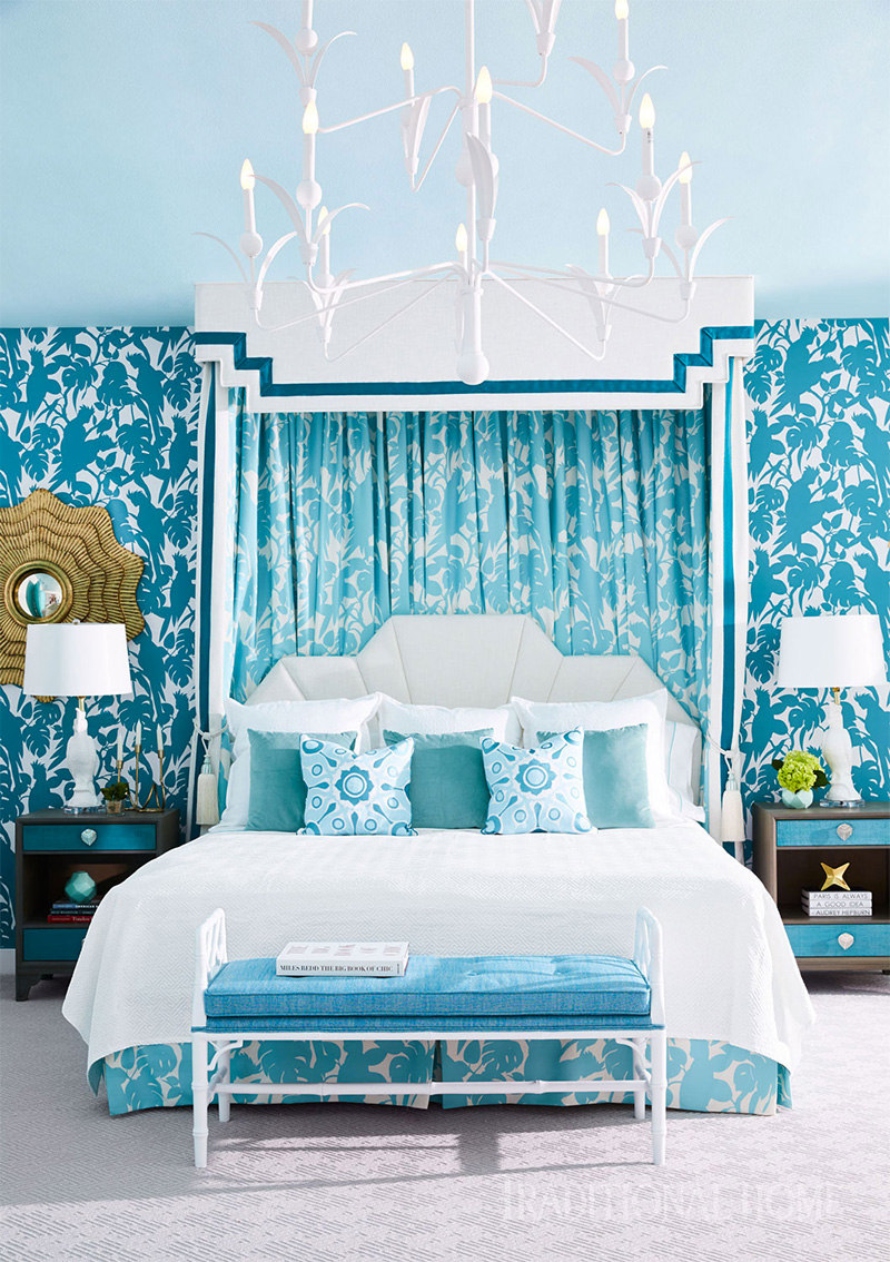 two lamps, bed, and chandelier with blue walls for traditional home magazine