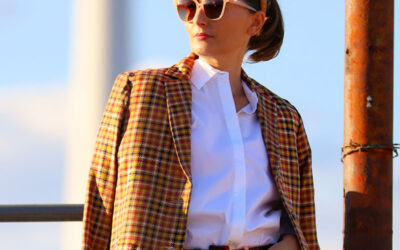 Fashion blogger Kelly Golightly wears a houndstooth blazer with pink velvet pants and a white button-down shirt.